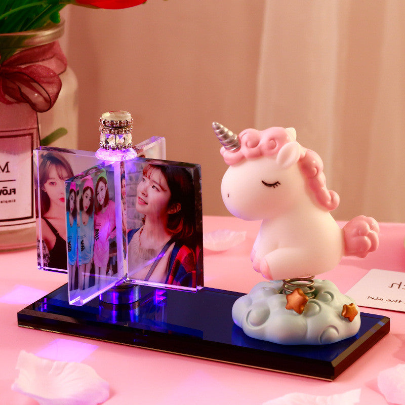 A personalized custom crystal photo frame featuring multiple photo slots and an integrated car perfume diffuser, paired with an adorable unicorn figurine. This unique, elegant display piece from FASHIONARIE CLUB serves as the perfect decorative accessory for car interiors or office desks, combining style, fragrance, and cherished memories in one premium, high-quality product.