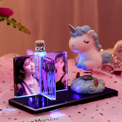 A personalized custom crystal photo frame featuring multiple photo slots and an integrated car perfume diffuser, paired with an adorable unicorn figurine. This unique, elegant display piece from FASHIONARIE CLUB serves as the perfect decorative accessory for car interiors or office desks, combining style, fragrance, and cherished memories in one premium, high-quality product.