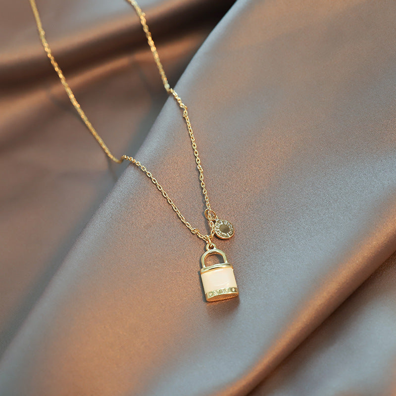 Close-up of an elegant gold floral-shaped geometric necklace with sparkling crystals, displayed on a dark surface for a luxury fashion look.