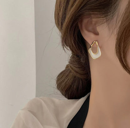 Close-up set of exquisite Korean style twisted enamel earrings with gold plating in multiple colors, trending fashion accessory for women in the UAE.