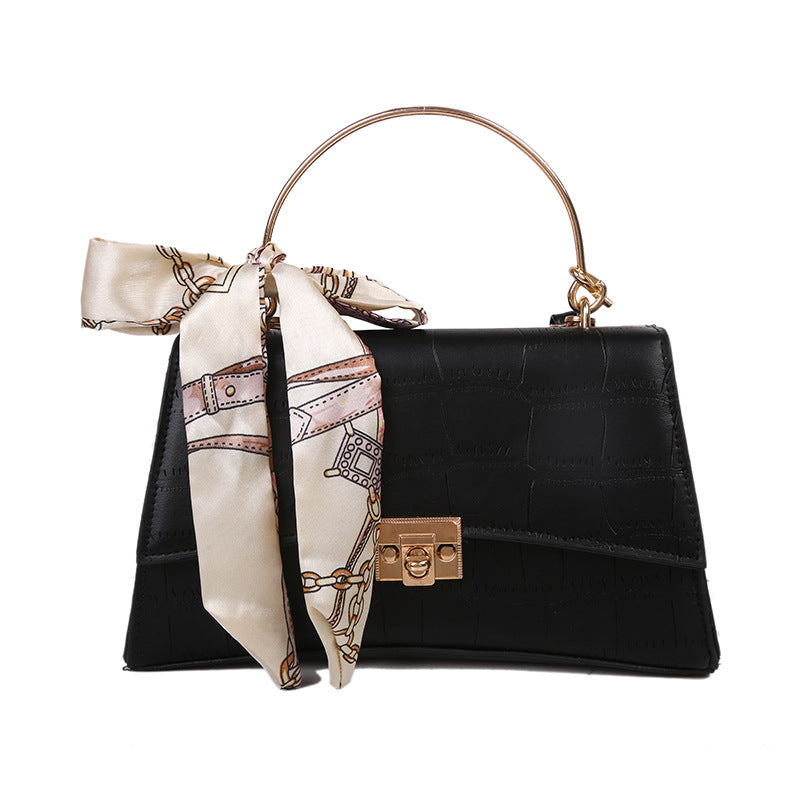 Stylish black textured crossbody handbag with decorative silk scarf accessory, perfect for modern daily and fashion-forward looks in the UAE.