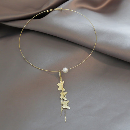 Close-up of an elegant gold floral-shaped geometric necklace with sparkling crystals, displayed on a dark surface for a luxury fashion look.