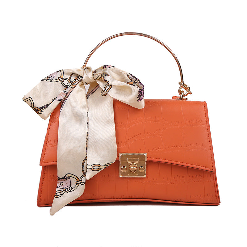 Stylish black textured crossbody handbag with decorative silk scarf accessory, perfect for modern daily and fashion-forward looks in the UAE.