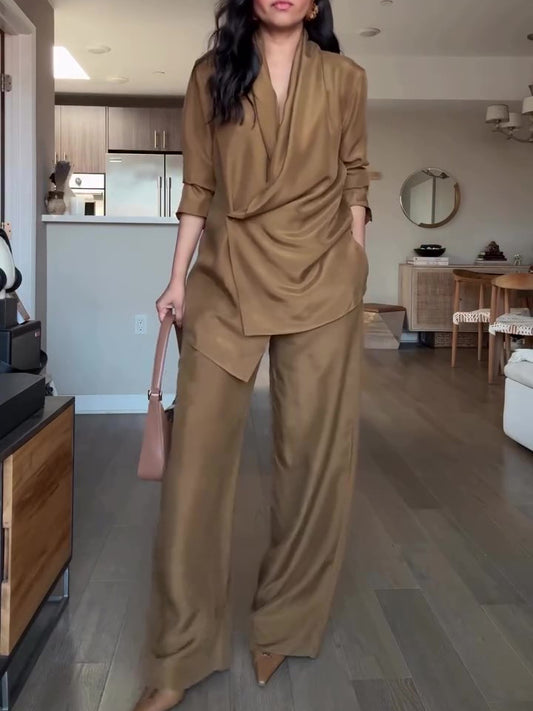 Elegant tan wrap-style satin blouse and wide-leg pants set, perfect for a sophisticated formal look.