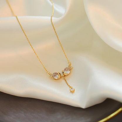 Close-up of an elegant gold floral-shaped geometric necklace with sparkling crystals, displayed on a dark surface for a luxury fashion look.