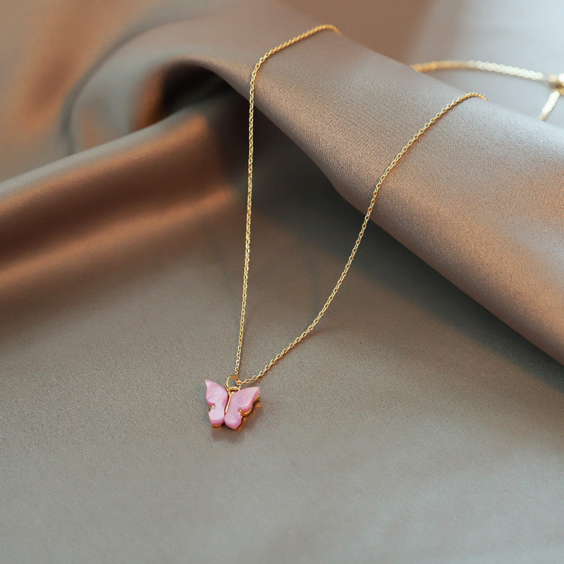 Close-up of an elegant gold floral-shaped geometric necklace with sparkling crystals, displayed on a dark surface for a luxury fashion look.