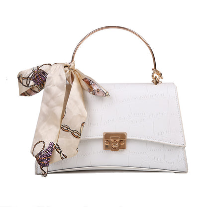 Stylish black textured crossbody handbag with decorative silk scarf accessory, perfect for modern daily and fashion-forward looks in the UAE.