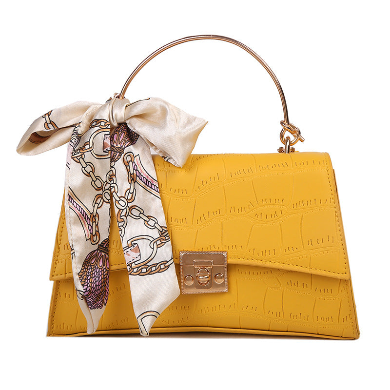 Stylish black textured crossbody handbag with decorative silk scarf accessory, perfect for modern daily and fashion-forward looks in the UAE.