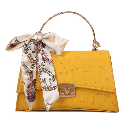 Stylish black textured crossbody handbag with decorative silk scarf accessory, perfect for modern daily and fashion-forward looks in the UAE.