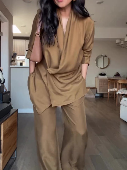 Elegant tan wrap-style satin blouse and wide-leg pants set, perfect for a sophisticated formal look.