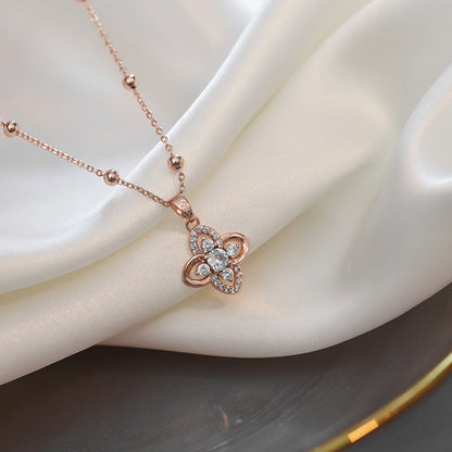 Close-up of an elegant gold floral-shaped geometric necklace with sparkling crystals, displayed on a dark surface for a luxury fashion look.