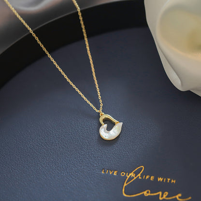 Close-up of an elegant gold floral-shaped geometric necklace with sparkling crystals, displayed on a dark surface for a luxury fashion look.