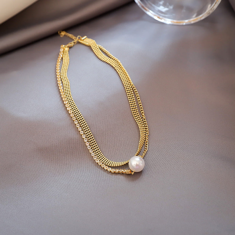 Close-up of an elegant gold floral-shaped geometric necklace with sparkling crystals, displayed on a dark surface for a luxury fashion look.
