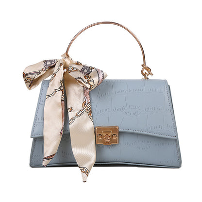 Stylish black textured crossbody handbag with decorative silk scarf accessory, perfect for modern daily and fashion-forward looks in the UAE.