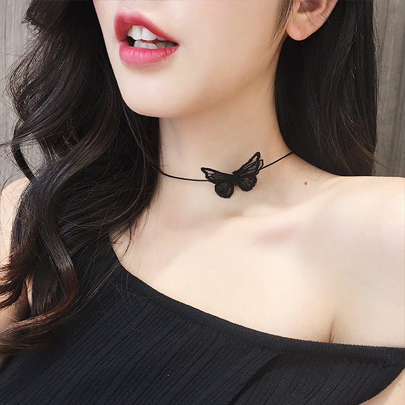 Close-up of an elegant gold floral-shaped geometric necklace with sparkling crystals, displayed on a dark surface for a luxury fashion look.