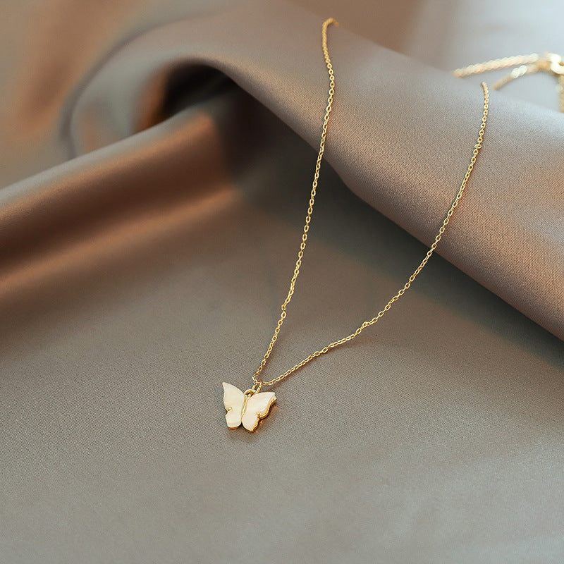 Close-up of an elegant gold floral-shaped geometric necklace with sparkling crystals, displayed on a dark surface for a luxury fashion look.