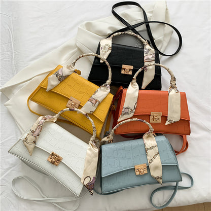 Stylish black textured crossbody handbag with decorative silk scarf accessory, perfect for modern daily and fashion-forward looks in the UAE.