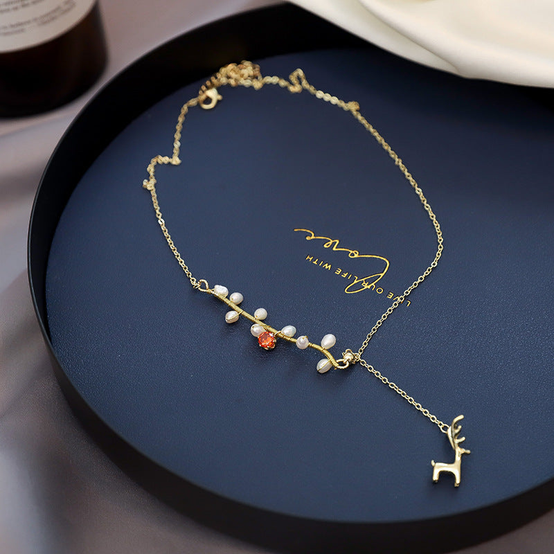 Close-up of an elegant gold floral-shaped geometric necklace with sparkling crystals, displayed on a dark surface for a luxury fashion look.